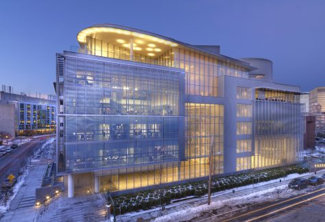 MIT Media Lab - a four story futuristic looking building with an all glass exterior